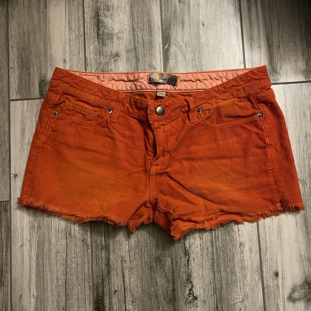 Paige low-rise orange corduroy shorts.